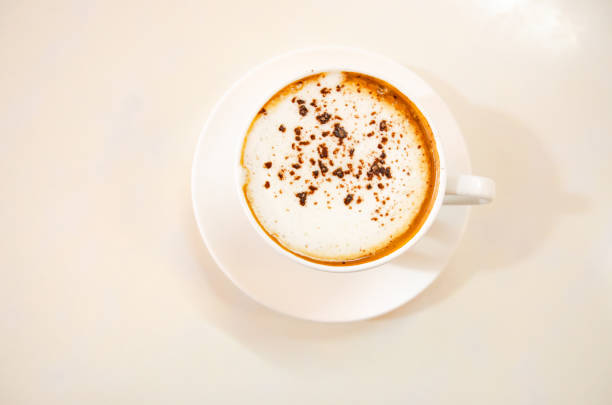 istock Cappuccino coffee on white table, photo taken in studio. Soft focus 1392949964
