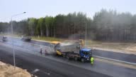istock The final stage of road works. Laying the top layer of hot gray tarmac mix 1392950090
