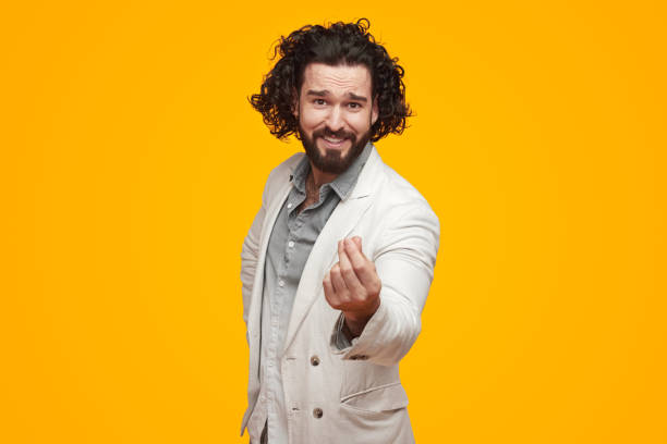 istock Smiling man showing money gesture in studio 1392954894