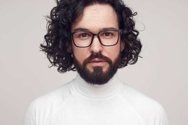 istock Handsome man with curly hair and in glasses 1392954904