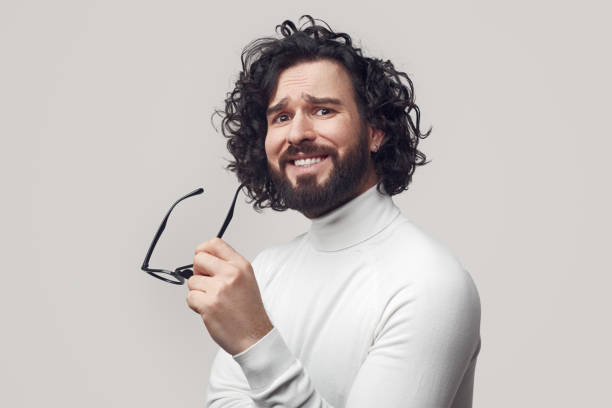Surprised bearded man with eyeglasses looking at camera