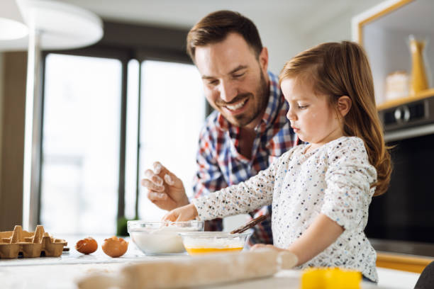 istock Father and daughter baking cookies 1392955132