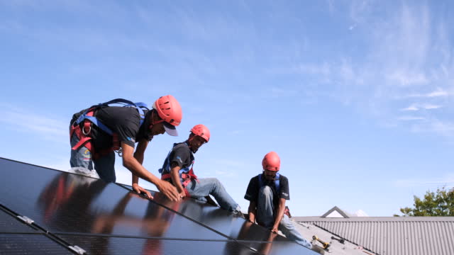 Installing and connecting solar panels on the roof of a house