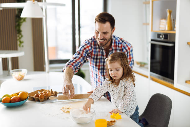 istock Father and daughter baking cookies 1392956301