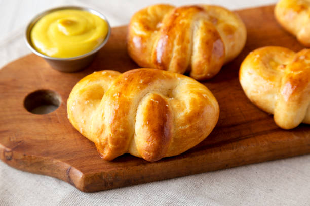 istock Homemade Basic Soft Pretzels with Mustard, side view. Close-up. 1392959545