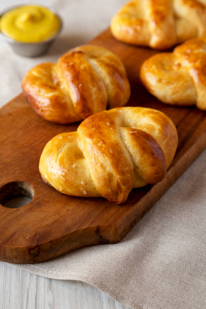 istock Homemade Basic Soft Pretzels with Mustard, low angle view. Close-up. 1392959562