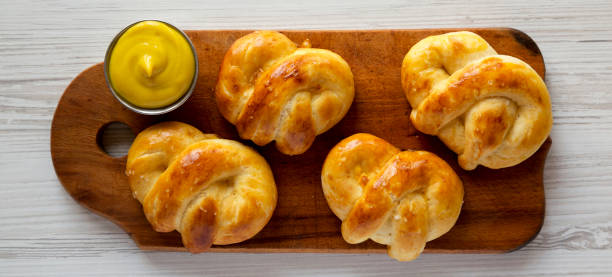 istock Homemade Basic Soft Pretzels with Mustard, top view. Flat lay, overhead, from above. 1392959660