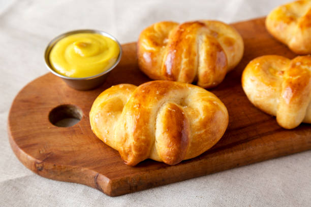 istock Homemade Basic Soft Pretzels with Mustard, low angle view. Close-up. 1392959747