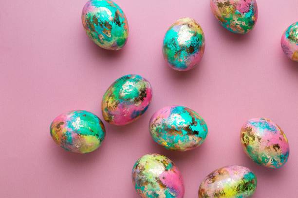 istock Minimalistic Easter composition. Golden paint eggs on pink background. Greeting trendy color concept. Top view, flat lay. 1392963422