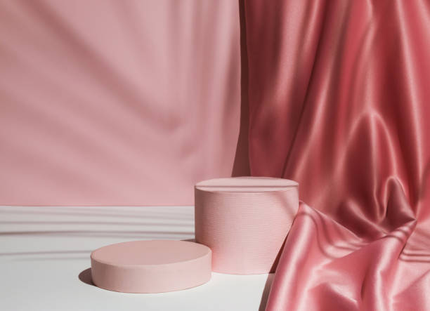 Pastel pink composition with satin curtain and palm leaf shadow. Suitable for Product Display and Business Concept. Modern aesthetic.