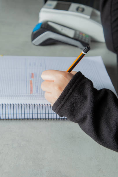 istock Woman writing in a notebook with a pen 1392969882