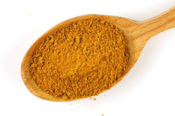 istock Curry powder seasoning in a wooden spoon isolate 1392970396