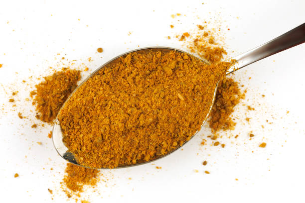 istock Curry powder seasoning in a metal spoon 1392970409