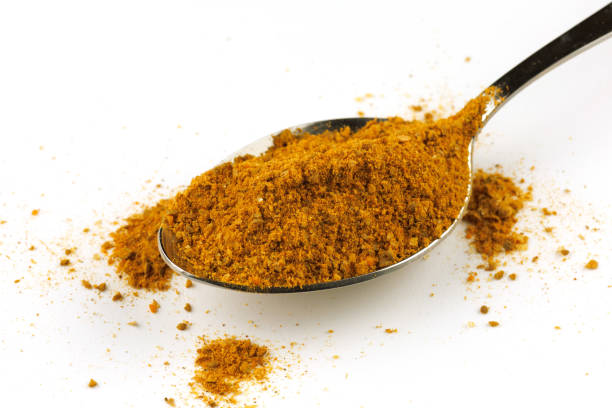istock Curry powder seasoning in a metal spoon 1392970438