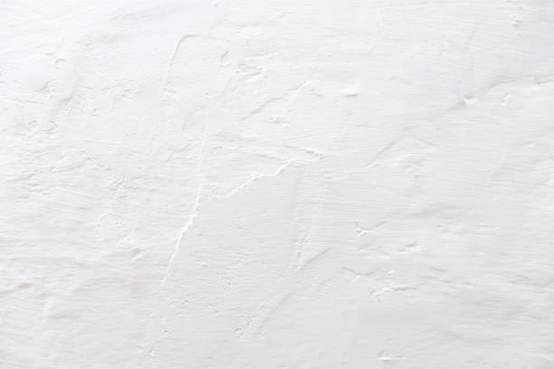 istock The texture of a plastered wall whitewashed with a fringe. 1392973091