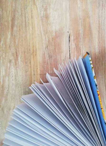 istock Books placed on brown wooden background 1392975263