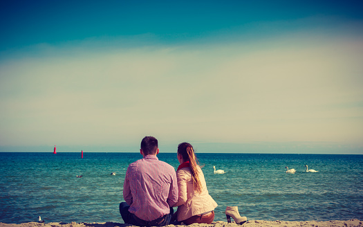 Romance, beautiful relantionship concept. Happy couple having date on beach near sea.