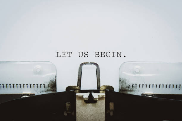 "let us begin"-text, der auf einer vintage-schreibmaschine getippt wurde - resume typewriter writing ideas stock-fotos und bilder