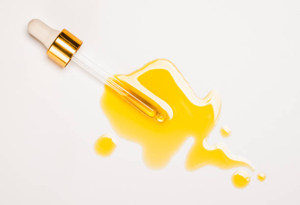 sérum à l’huile produit de beauté gouttes et compte-gouttes avec huile sur fond blanc - huile de massage photos et images de collection