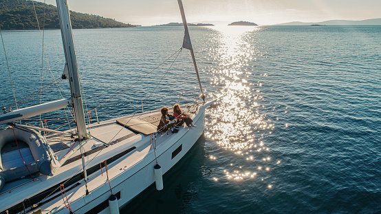 A luxury private motor yacht under way on tropical sea with bow wave