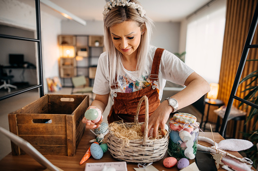 Woman sets up decorations for the Easter holidays in her home