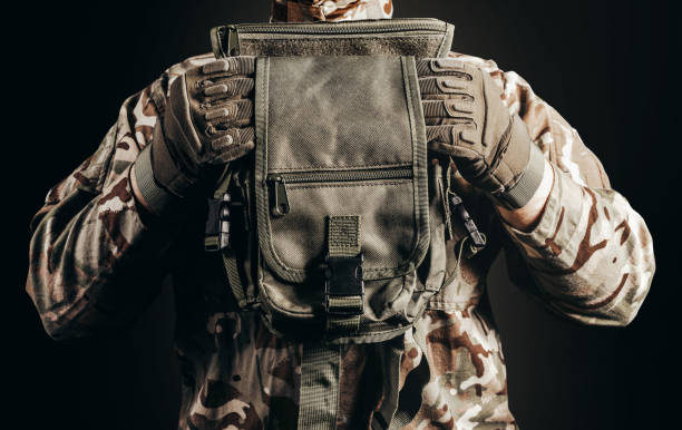 istock Soldier in gloves holding tactical leg bag. 1392984331