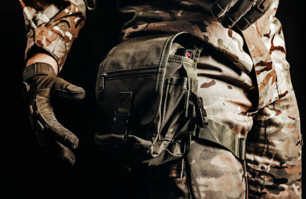 istock Soldier in tactical gloves using leg bag. 1392984351