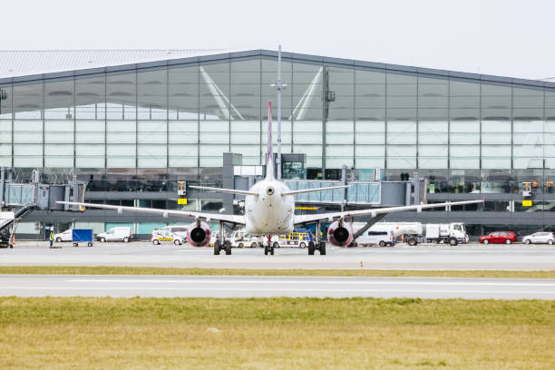 istock Airplane on the passenger terminal background. 1392986620