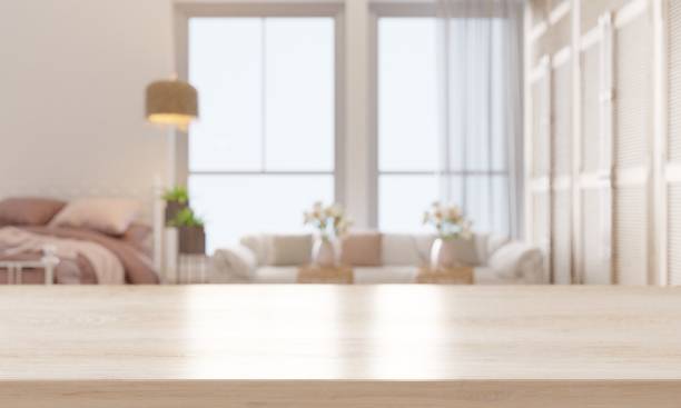 Empty wooden table top with sofa and bed.