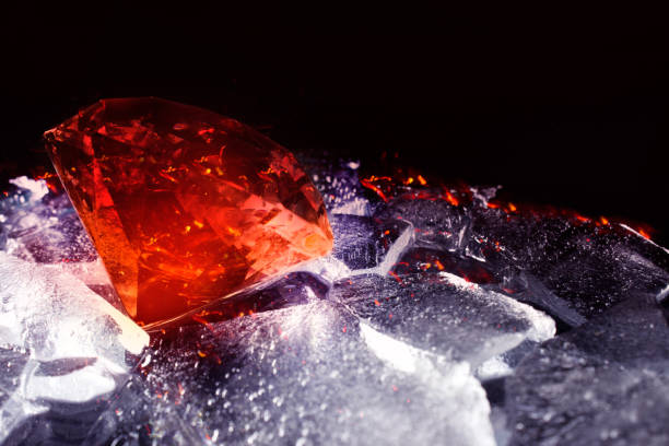 istock Blood red diamond laying on broken ice. 1392986707