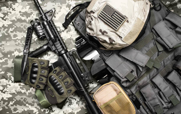 istock Military tactacal bulletproof vest with rifle. 1392986793