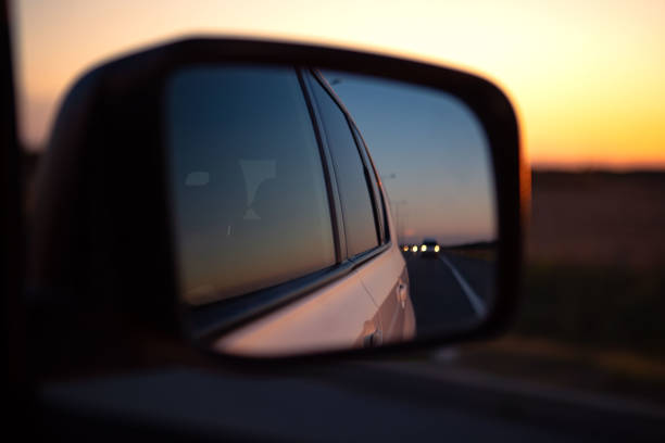 istock reflection in car rear mirror sunset on the road 1392988667