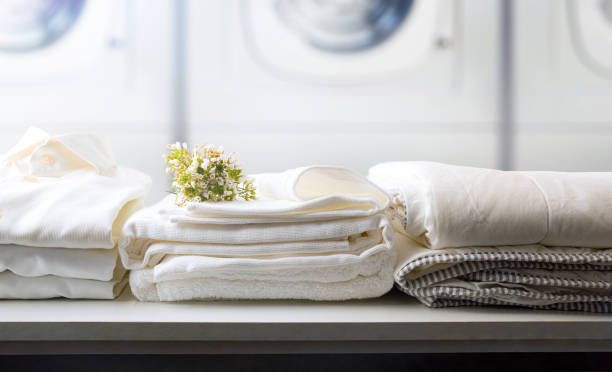 istock Self-service laundry with textiles on bench and washing machines background 1392989545