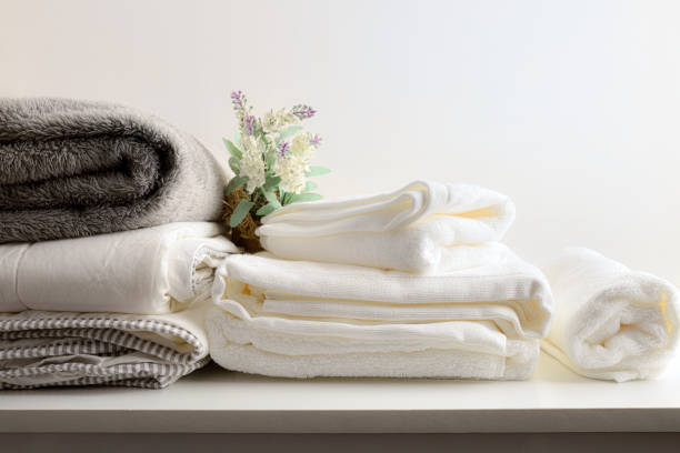 istock Clothes cleaning service with bedding on bench and isolated background 1392989562