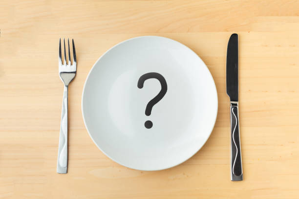 istock Empty white plate on wooden table. background for restaurant menu 1392989635