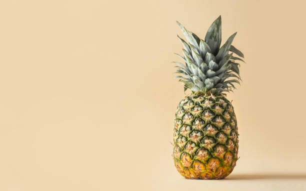 istock Whole pineapple isolated on the beige background 1392989706
