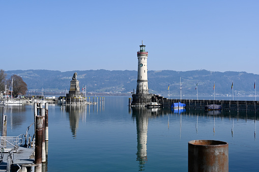 Lindau, Germany, March 28, 2022 - Harbor entrance of Lindau on Lake Constance with lighthouse and Bavarian lion