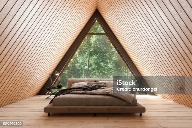 Wooden Tiny House Interior With Bed Furniture And Triangular Window Stock Photo - Download Image Now