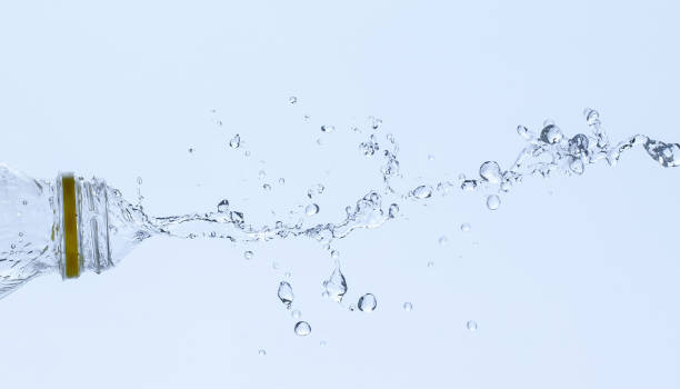 istock Splash of water from a bottle on a white background. 1392993475
