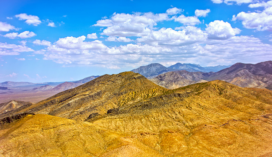 Aerial view of mountain ranges against cloudy sky in Nevada, California, USA.