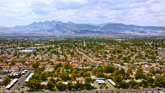 Aerial view of residential district with mountain range in background against sky, Nevada, California, USA.