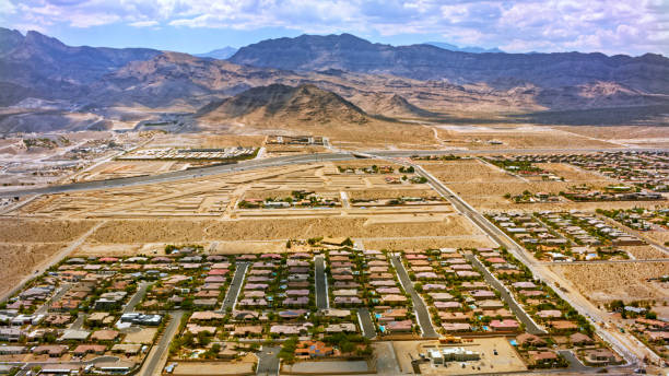 Aerial view of residential district with desert landscape against mountain range and sky, Nevada, California, USA.