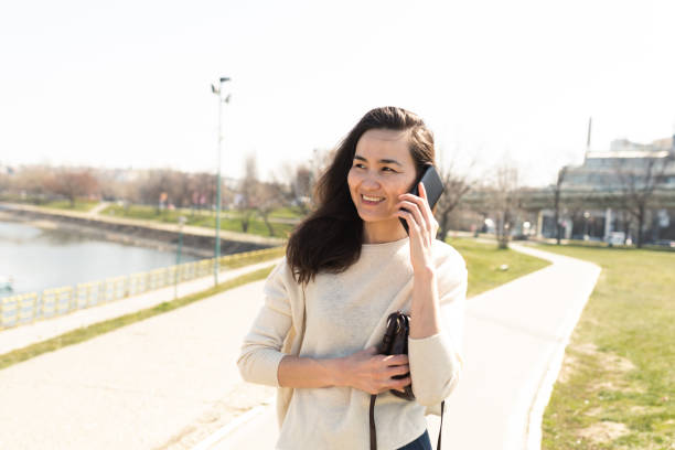 istock Asian woman walking and telephoning 1393000700