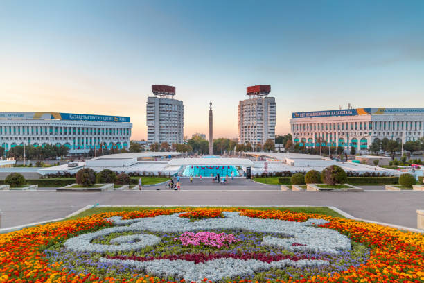 Almaty Republic Square with flower bed and independence monument. Almaty, Kazakhstan - September 05, 2021