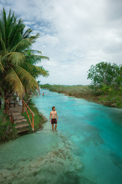 istock Man swimming in Bacalar Lagoon in Mexico 1393004450