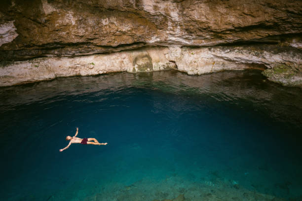 istock Man swimming  in Cenote in Yucatan, Mexico 1393005520