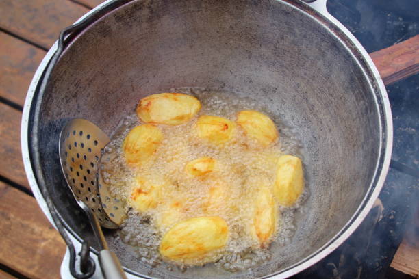 istock Potatoes are fried in oil in a cauldron. 1393009668