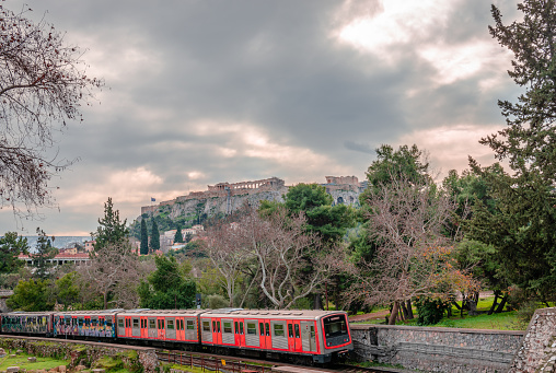 Athens, Greece - January 30 2022: The Metro of Athens in Monastiraki, running along the Ancient Agora with the Acropolis in the background.