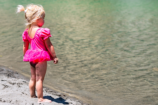 Caucasian Little girl looking at the water