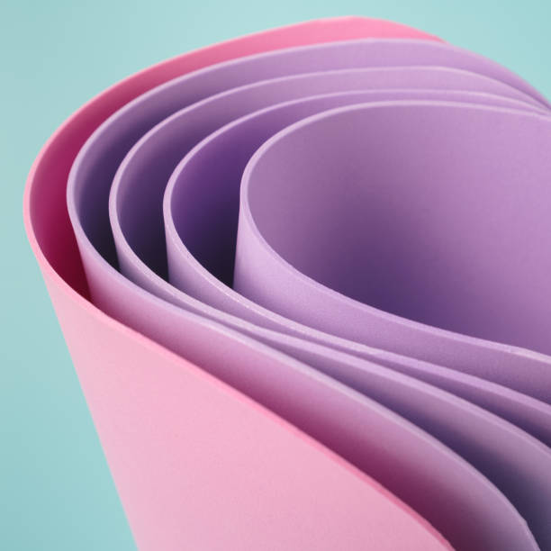 istock Abstract colorful sheets curved against the pastel blue background. 1393012466